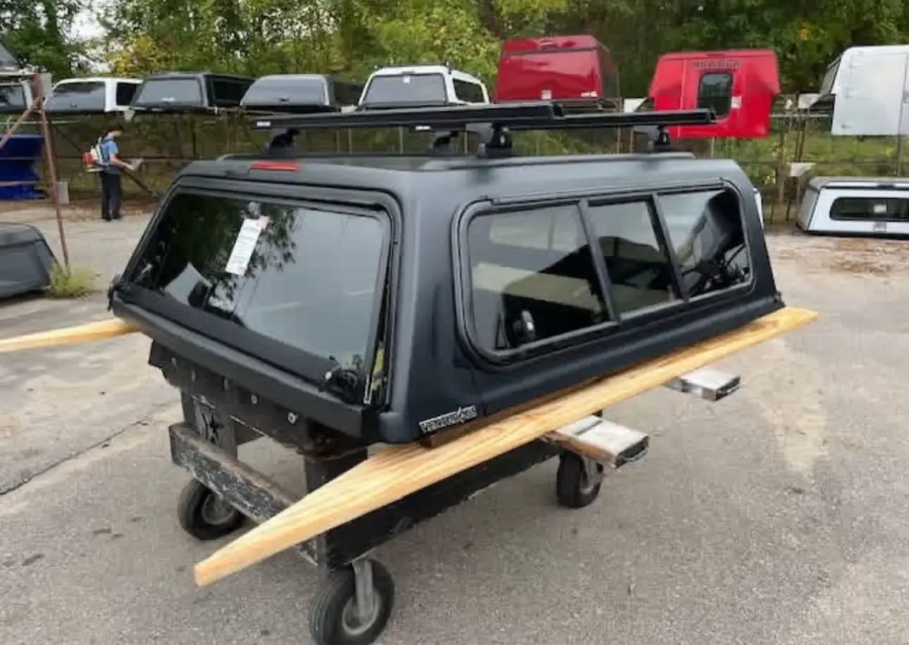 Toyota Tacoma fiberglass camper shell installed on pickup truck, Toyota Tacoma truck cap with side windows, Toyota Tacoma bed topper with rear liftgate, Toyota Tacoma camper shell with sliding side windows, Toyota Tacoma high-rise camper shell for pickup bed, Toyota Tacoma cab-height truck topper, Toyota Tacoma commercial-style camper shell, Toyota Tacoma aluminum truck topper for cargo protection, Toyota Tacoma overland camper shell with roof rack, Toyota Tacoma truck cap with integrated roof rack, Toyota Tacoma camper shell with side access windows, Toyota Tacoma pickup bed canopy with rear door, Toyota Tacoma hard shell truck topper, Toyota Tacoma fiberglass bed canopy, Toyota Tacoma truck topper with tinted windows, Toyota Tacoma camper canopy for outdoor and camping use, Toyota Tacoma pickup with fitted camper shell, Toyota Tacoma bed topper for secure cargo storage, Toyota Tacoma camper shell with raised roof design, Toyota Tacoma high-roof truck cap for camping,