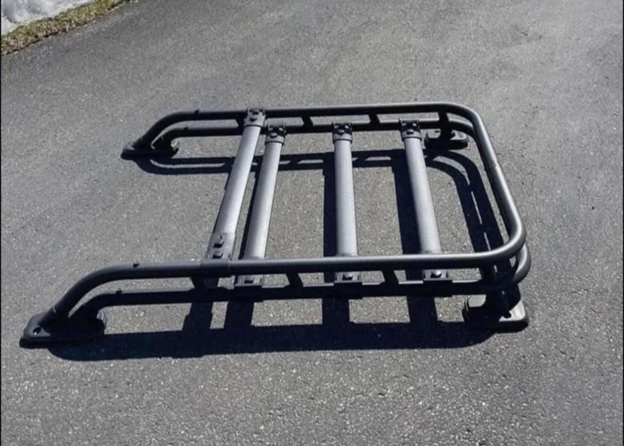 Toyota Tacoma roof rack mounted on pickup truck for cargo and outdoor gear, Toyota Tacoma aluminum roof rack with full-length platform, Toyota Tacoma low-profile roof rack with crossbars, Toyota Tacoma heavy-duty off-road roof rack for overlanding, Toyota Tacoma premium modular roof rack with accessory mounting points, Toyota Tacoma roof rack with LED light bar and cargo platform, Toyota Tacoma factory-style roof rack for camping equipment, Toyota Tacoma roof cargo rack installed on double cab pickup, Toyota Tacoma black powder-coated roof rack for outdoor adventures, Toyota Tacoma expedition roof rack with modular platform design,