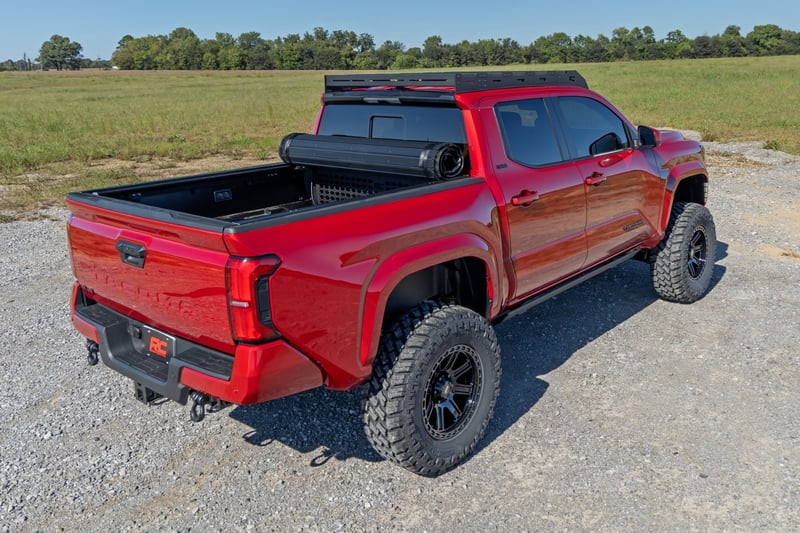 Toyota Tacoma soft roll-up bed cover installed on pickup truck, Toyota Tacoma black vinyl roll-up tonneau bed cover, Toyota Tacoma premium soft roll-up tonneau cover, Toyota Tacoma hard roll-up bed cover with aluminum slats, Toyota Tacoma low-profile hard roll-up tonneau cover, Toyota Tacoma roll-up truck bed cover closed view, Toyota Tacoma roll-up tonneau cover partially opened, Toyota Tacoma roll-up bed cover with cargo area exposed, Toyota Tacoma hard roll-up tonneau cover side view, Toyota Tacoma roll-up bed cover for 5-foot truck bed,