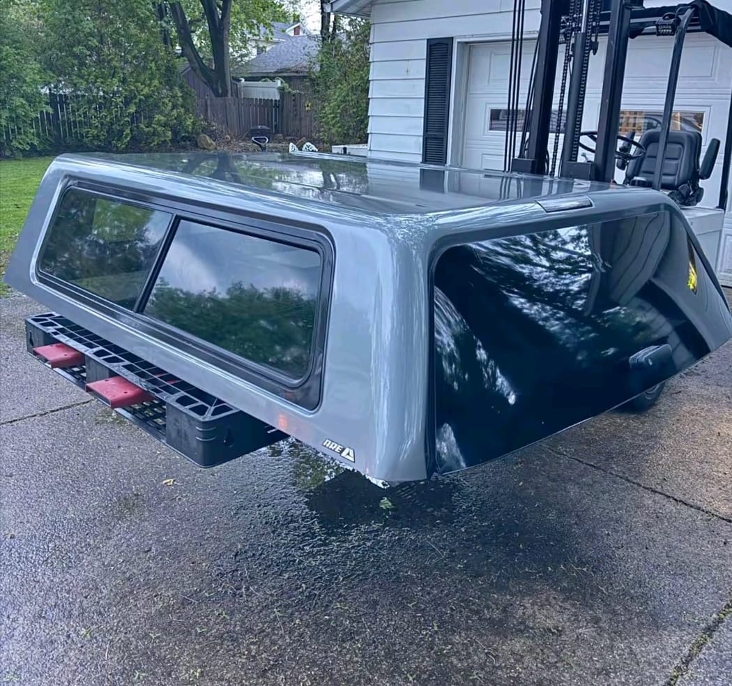 GMC Sierra camper shell truck cap installed on pickup bed, GMC Sierra 1500 fiberglass camper shell, GMC Sierra aluminum truck camper shell, GMC Sierra pickup bed topper with side windows, GMC Sierra heavy duty commercial camper shell, GMC Sierra overland truck cap for camping, GMC Sierra premium painted camper shell, GMC Sierra truck topper with rear lift window, GMC Sierra 2500 HD camper shell bed cap, GMC Sierra 3500 HD heavy duty truck cap,